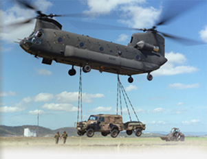 Chinook with underslung Landrover 110 with _ tonne trailer.